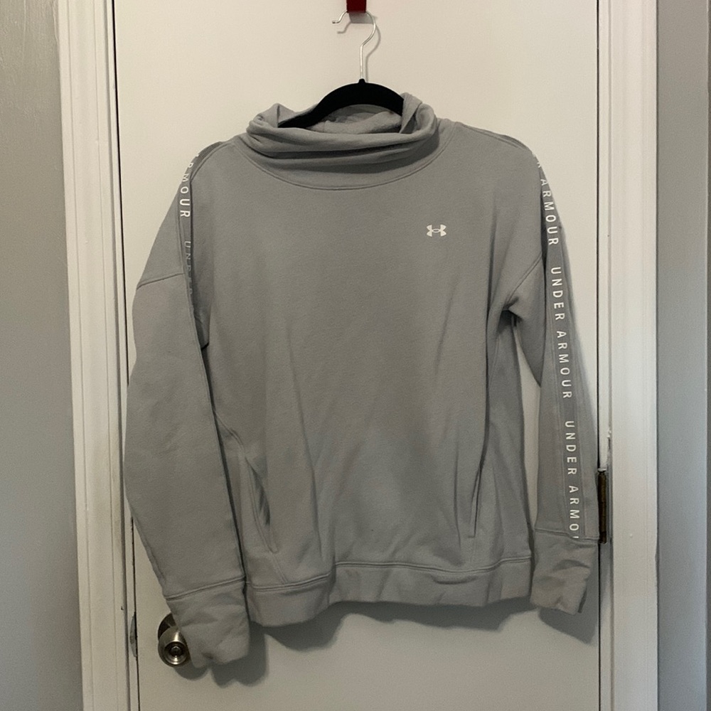 Medium grey Under Armour women’s sweatshirt with cowl neck. Has pockets.